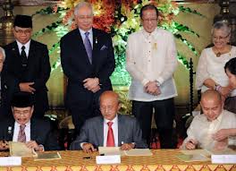 Phil Rep Marvic Leonen and MILF negotiator Mohagher Iqbal sign the documents