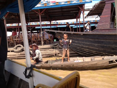 Boy Plays with his pet snake at Ton Le Sap Lake